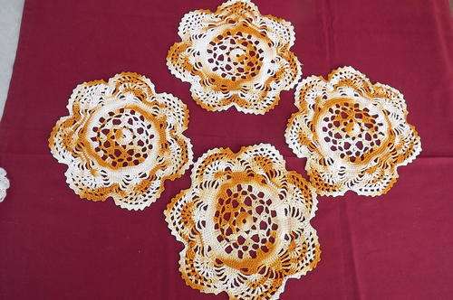 Set of 4 small orange shade crocheted doilies 22 cm diameter each in good condition
