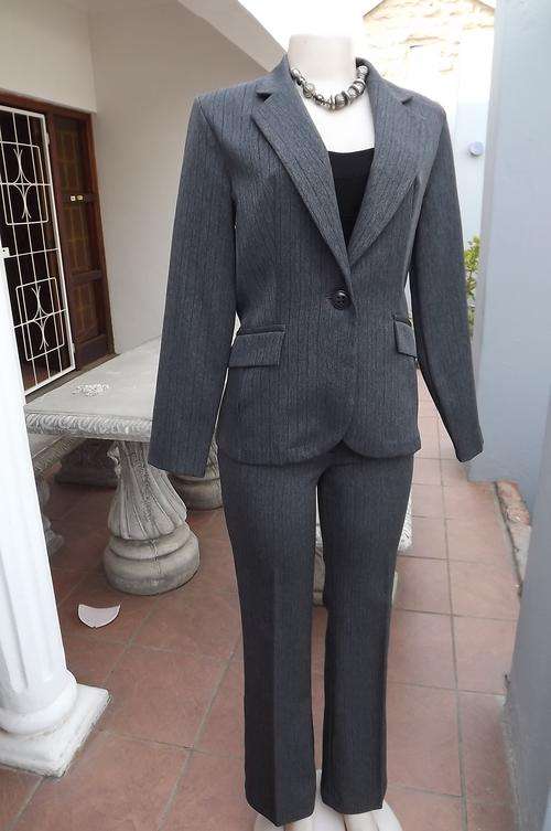 Elegant grey with thin black stripe 2 piece pant suite.Size 32/8.100% wash&wear polyester.