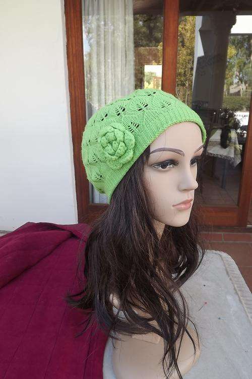 Pretty hand knitted neon green beret n lace pattern with knitted flower at side.Very good condition