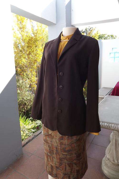 Elegant brown jacket in choc brown.Fully lined with 2 side pockets by ML Classics.Size 32/8.