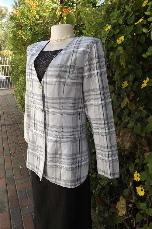 Tailored collarless jacket in beige/brown check.Dummy pockets by Chelsea West size 36/12.Button down