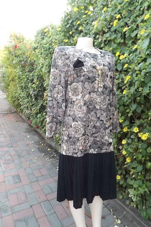 Warm dress for winter by Charlotte with extended waistline size 40/16.Black with beige rose design