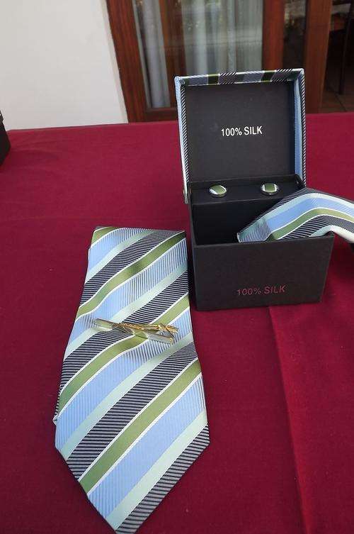 Boxed 100% silk 4 piece tie set.Diagonally striped in light blue and greens.Handmade tie.Pocket hank