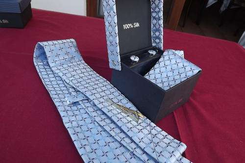 Boxed 100% silk 4 piece tie set.Beautifully patterned with crosses on light blue background.Width 10