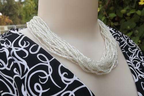 Costume jewelery multi string beaded choker in Pearl colour.Look stunning with dark colours.New cond