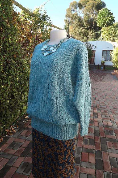Hand knitted turquoise ladies sweater in acrylic wool.Size 38/14.Cable stitch and wide ribbing.