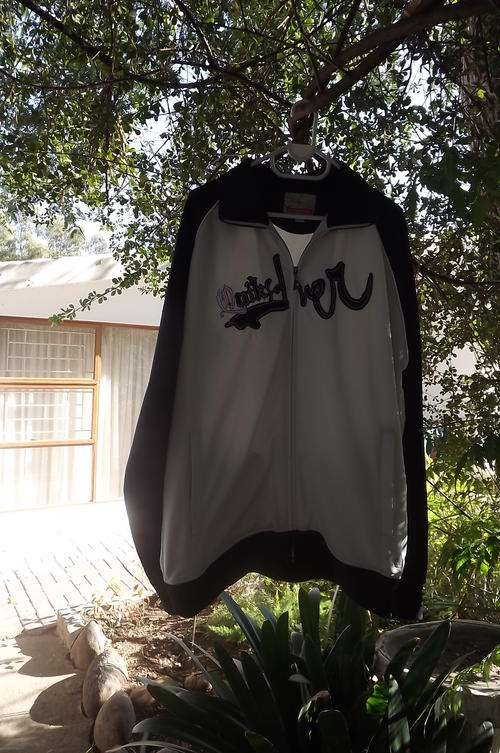 Black and White XXL Quicksilver zipped up jacket.Front sided pockets.100% Polyester with fleezy insi