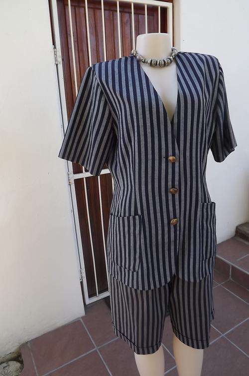 Classic 2piece short pant suit with jacket in navy/grey stripe.Size 38/14 by Merien Hall.High waiste