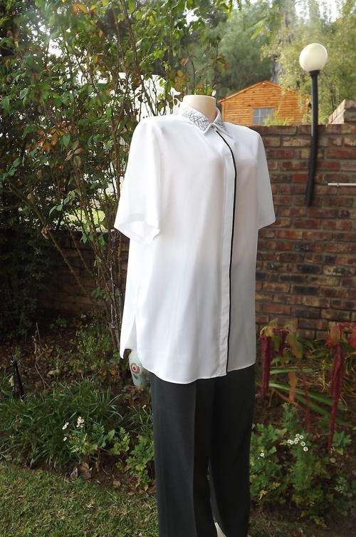 Fabulous white short sleeve blouse from PennyC size 42/18 with embroidered collar.Black satin edging