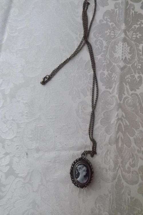Brass quartz watch working 100% with imitation cameo cover and 80cm chain.New condition