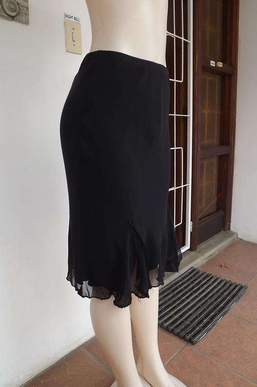 Black Truworths glamour skirt.Two layers.Size 34/10.Uneven seamline.Elasticated middle.Good conditio