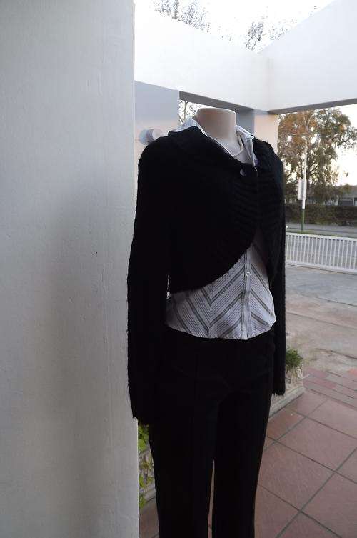Black soft knitted bolero top closing with 1 large button on front.Size 36/12.Wide fold over collar.