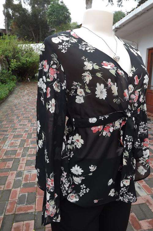 Black sheer romantic and sexy black floral top in size 32/8.V neck front.Tie on high middle front.