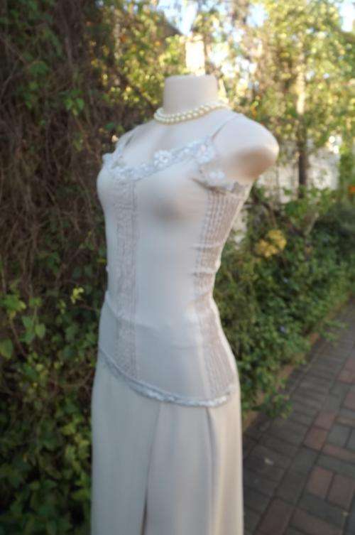 Beige lycra strappy top with lace and tucking decoration.Size 36/12.Adjustable straps.
