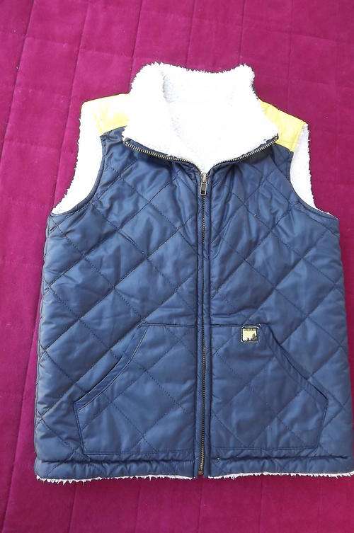 Warm polyester waistcoat with faux fur lining for boy of 5-6 years old by Woolworths.2 Front pockets