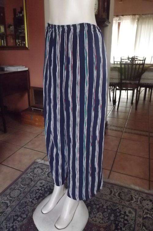 Comfortable navy pants with colourful vertical stripes.Size 42/18.Made by owner.Elasticated waist.