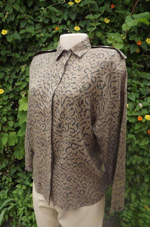 Animal print blouse by Depeche in size 34/10.Tan and Black colours.Epulets on shoulders.Shirt collar