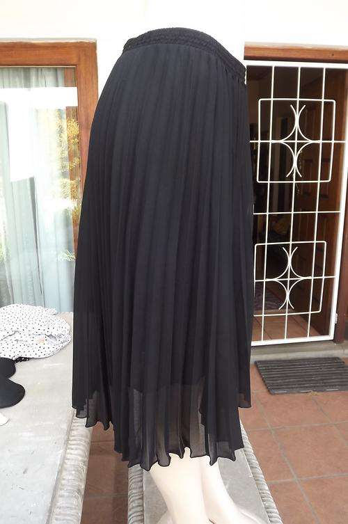 Black Donatella permanent pleated size 40/16 skirt.Lined.In 100% polyester fabric.Elasticated middle