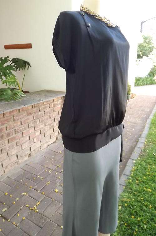 Black silky blouson style pull over top with short slit at back - Size 38/14. New condition.