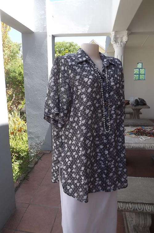 Black and  white blouse with pretty small white floral pattern.Size 46/22.As new.