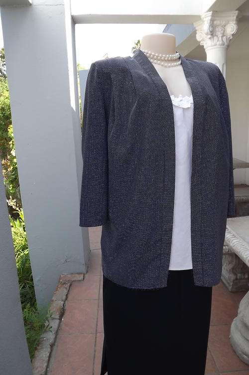 Elegant navy and white light weight polka dot open jacket.Size 38/14. Threequarter sleeves.