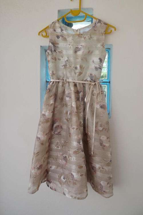 Pretty special occasion dress in  sheer cream polyester with suble purple/brown roses.  8 to 9 years