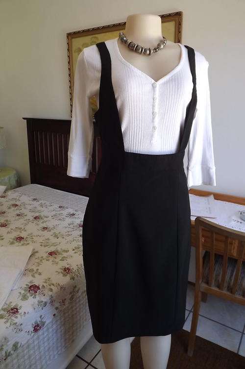 Black pinafore from RT size 38/14.Stretch rayon/ polyester blend.As new.