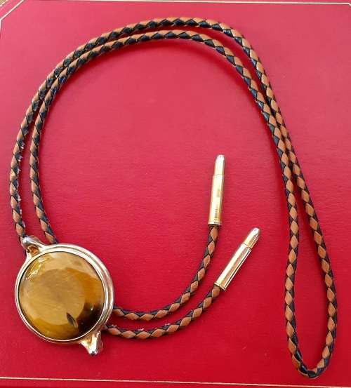 ANTIQUE  TIGER EYE AND BRAIDED LEATHER MENS NECK BOLO TIE WITH BULLET ENDS.