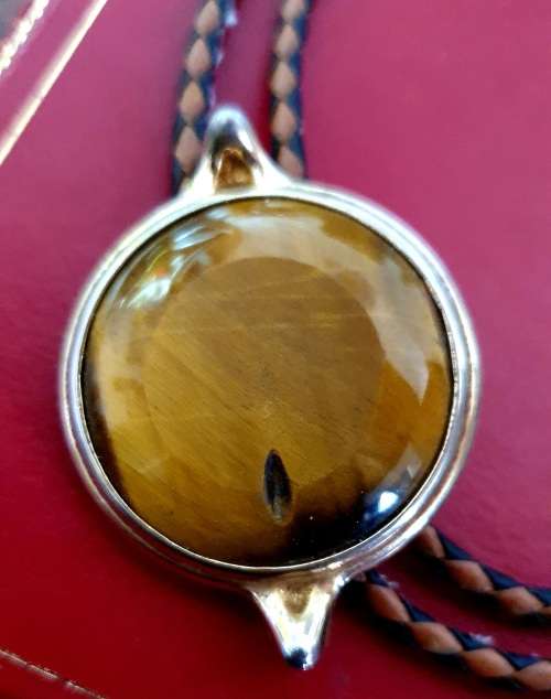 ANTIQUE  TIGER EYE AND BRAIDED LEATHER MENS NECK BOLO TIE WITH BULLET ENDS.