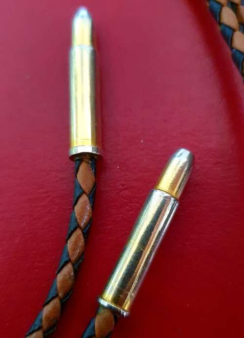 ANTIQUE  TIGER EYE AND BRAIDED LEATHER MENS NECK BOLO TIE WITH BULLET ENDS.