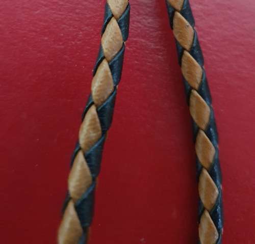 ANTIQUE  TIGER EYE AND BRAIDED LEATHER MENS NECK BOLO TIE WITH BULLET ENDS.