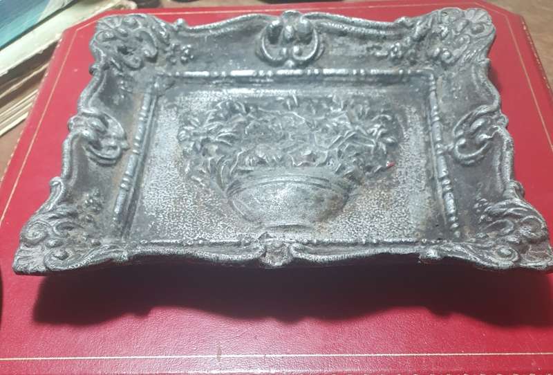 Antique cast iron framed flowers wall plate.