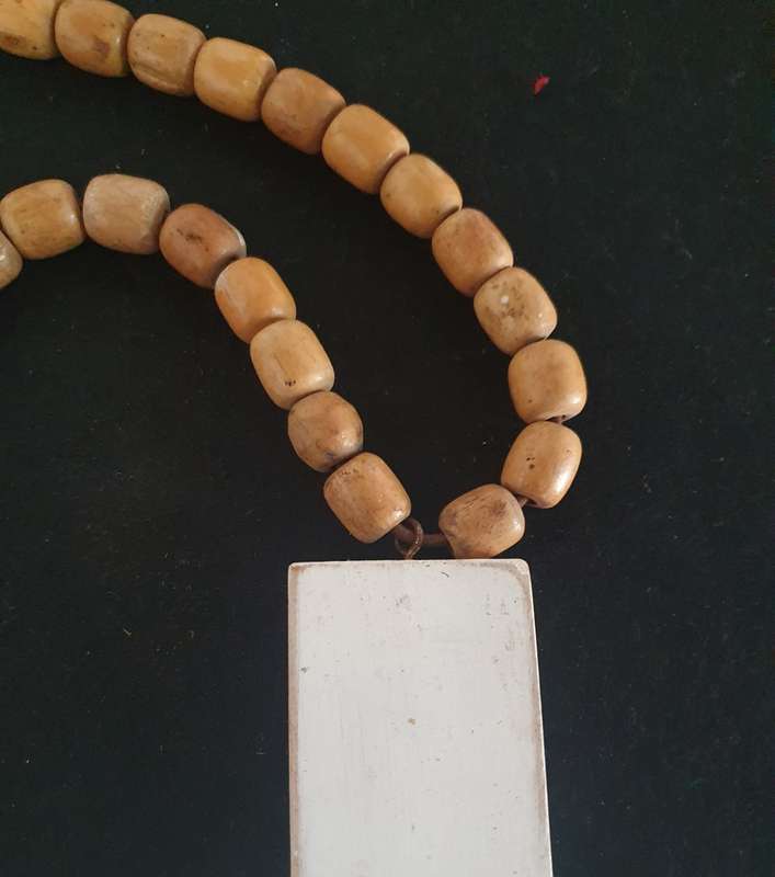 Huge wood cross with wooden beads.