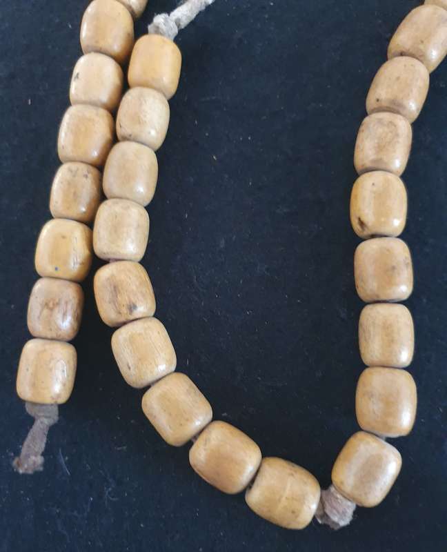 Huge wood cross with wooden beads.