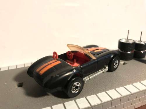 Hot Wheels AC Cobra from late 80s. Black with Black wall Tyres