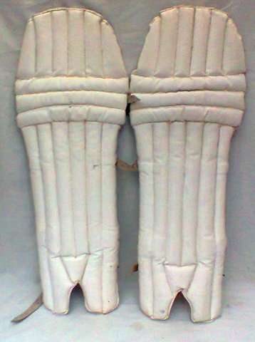 WHITE CRICKET PADS WITH LEATHER STRAPS ON BUCKLE IS MISSING