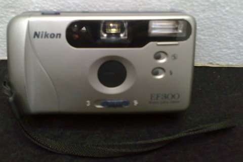 Nikon EF300 29mm Camera takes 2 pen light batteries with pouch