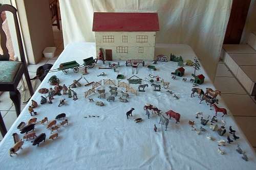 A lovely vintage toy farmhouse with 100 lead farm animals and implements/ accessories