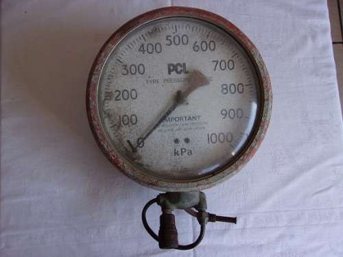 Vintage red PCL tyre pressure gauge for display