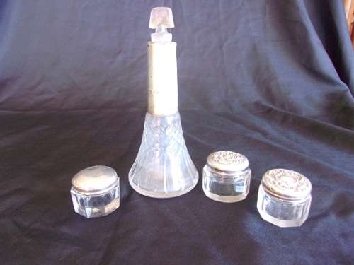 3 antique crystal dressing table bottles with silver lids & a perfume bottle with silver collar