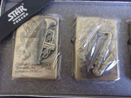Boxed set of 4 Star fuel cigarette lighters - musical instrument theme