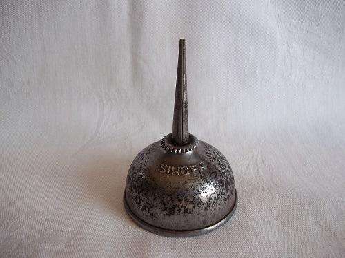 A tiny vintage Singer oil can thumb applicator