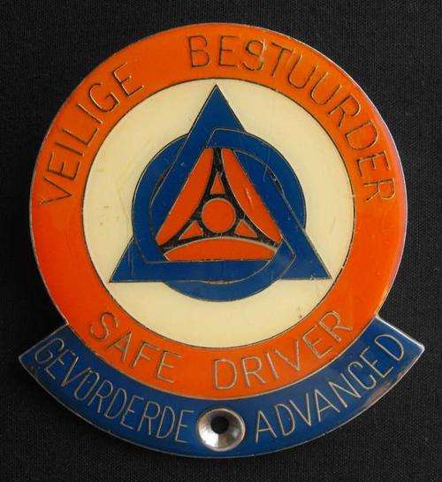 OLD ADVANCED SAFE DRIVER BILINGUAL METAL CAR BUMPER BADGE
