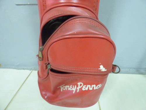 A FANTASTIC RED TONEY PENNA GOLF BAG WITH A TONEY PENNA GOLD 1, TI BUBBLE 2 & 4 PUTTERS.