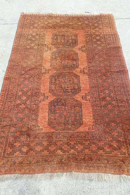 AN INCREDIBLE ANTIQUE PERSIAN CARPET (2.1m x 1.3m) IN EARTHY TONES ENCOMPASSED IN CLARET RED COLOURS