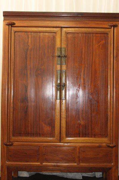AN INCREDIBLE ANTIQUE DOUBLE DOOR CHINESE CABINET WITH TRADITIONAL HANDLES AND HINGES AND A DRAWER