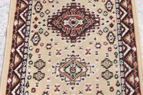 A FABULOUS 2.6m LONG "KHALAF ORIENT" RUNNER CARPET IN DARK BROWN AND TAN COLOURS