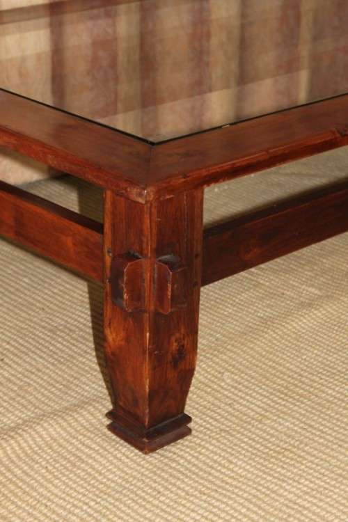 An exquisitely made solid wooden centre coffee/ occasional table with a toughened glass top RS17