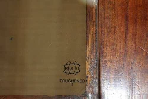 An exquisitely made solid wooden centre coffee/ occasional table with a toughened glass top RS17