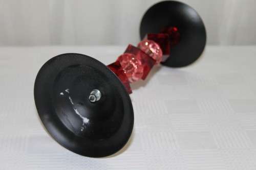 AN AWESOME TALL "MODERN" BLACK METAL CANDLE HOLDER WITH A PINK AND RED BEADED STEM